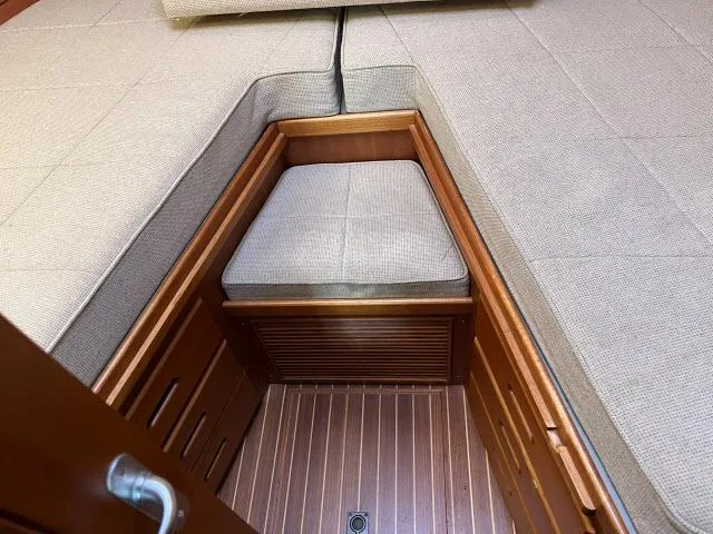 Slide: The Image of Interior cabin of 1999 Grand Banks Eastbay 38 with cushioned seating. - 18