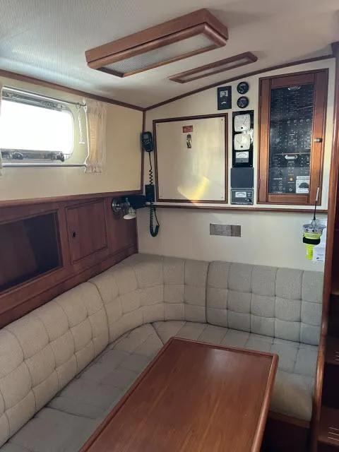 Slide: The Image of Cozy interior of 1999 Grand Banks Eastbay 38 with seating and control panel. - 2