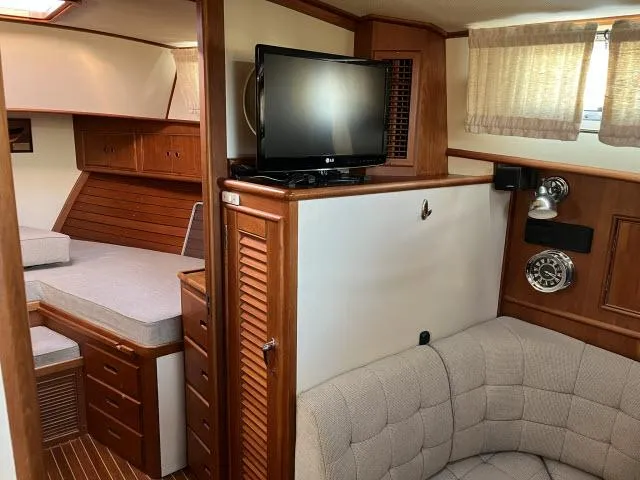 Slide: The Image of Interior of 1999 Grand Banks Eastbay 38 yacht with cozy seating and TV. - 4