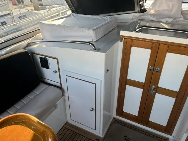 Slide: The Image of Interior of 1999 Grand Banks Eastbay 38 yacht with seating and storage cabinets. - 41