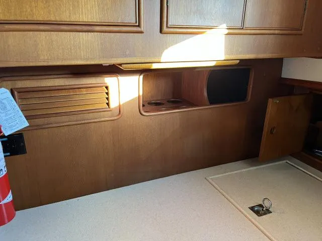 Slide: The Image of Interior of 1999 Grand Banks Eastbay 38 yacht with wooden cabinetry and countertop. - 8