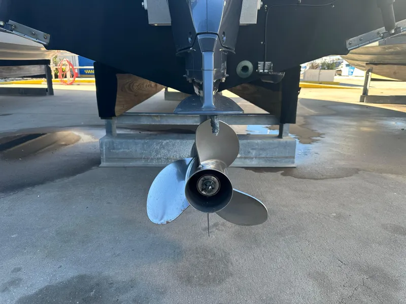 Slide: The Image of Close-up of a 2022 NauticStar Legacy 2302 boat propeller on display. - 15