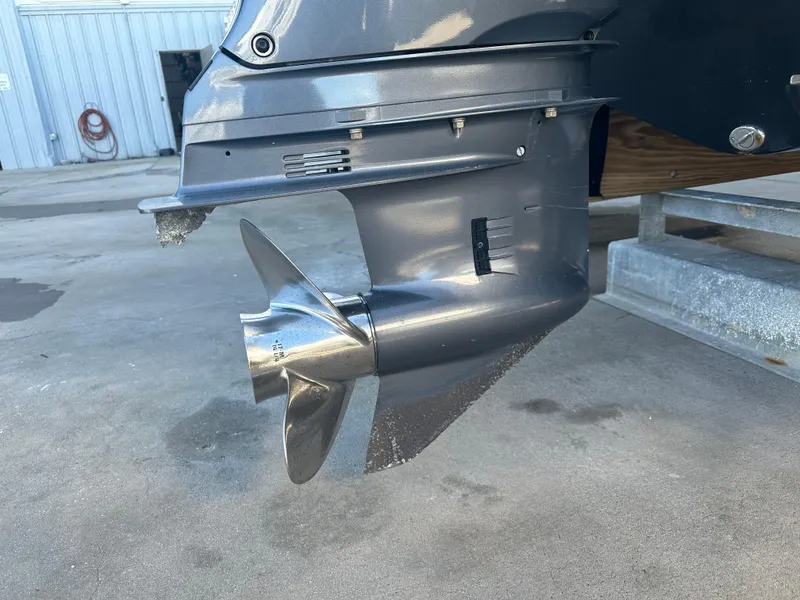 Slide: The Image of Close-up of 2022 NauticStar Legacy 2302 boat propeller and lower unit. - 20