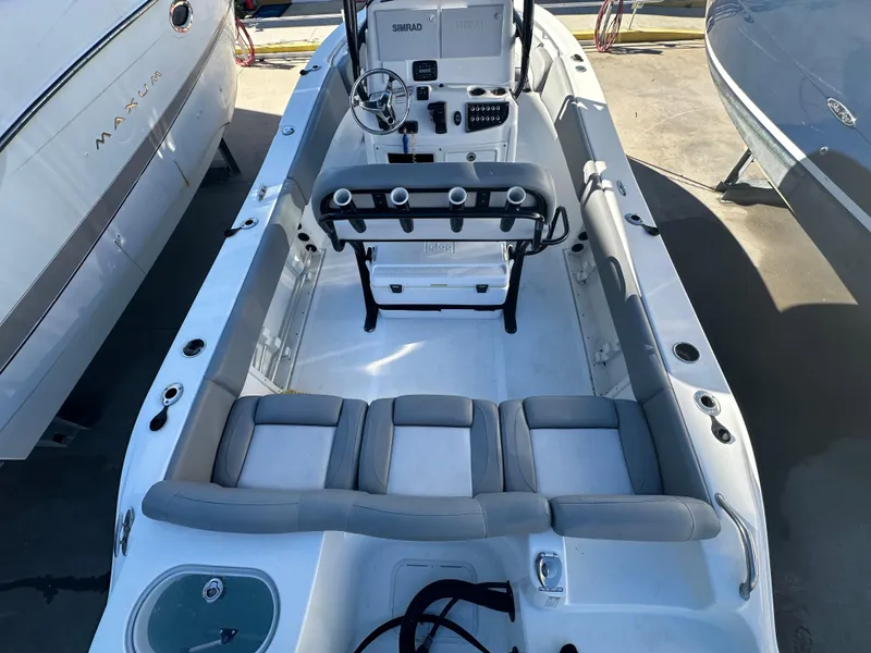 Slide: The Image of 2022 NauticStar Legacy 2302 boat interior with seating and console. - 21