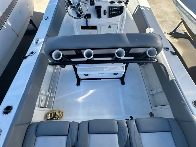 Slide: The Image of 2022 NauticStar Legacy 2302 boat interior with seating and console. - 24