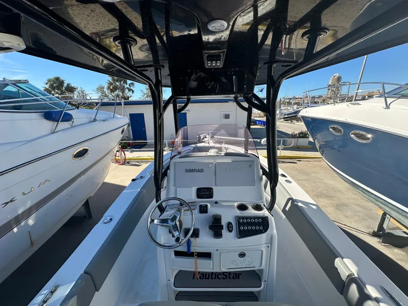 Slide: The Image of 2022 NauticStar Legacy 2302 boat interior with steering console and controls. - 28