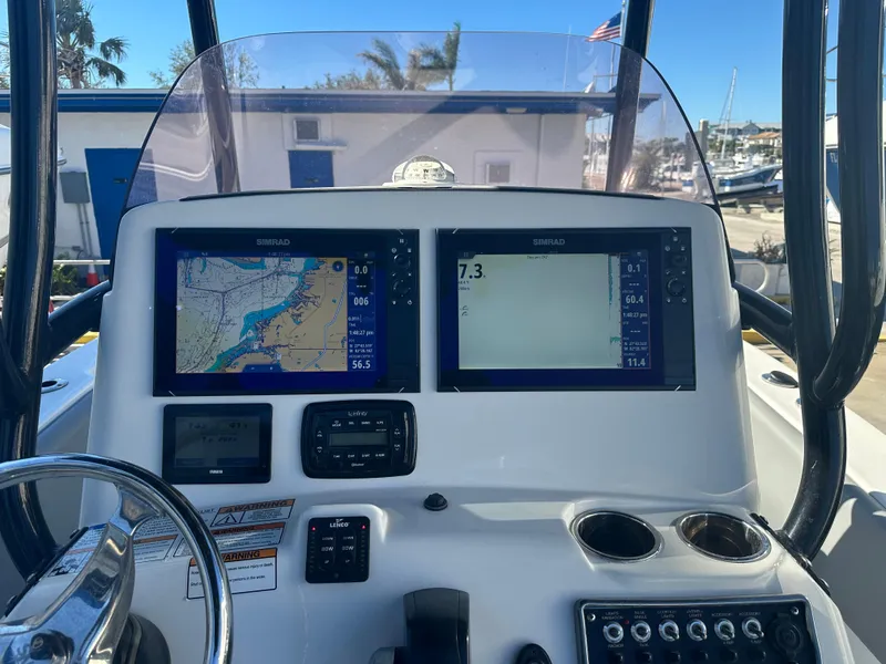 Slide: The Image of NauticStar Legacy 2302 boat dashboard with dual navigation screens, 2022 model. - 30