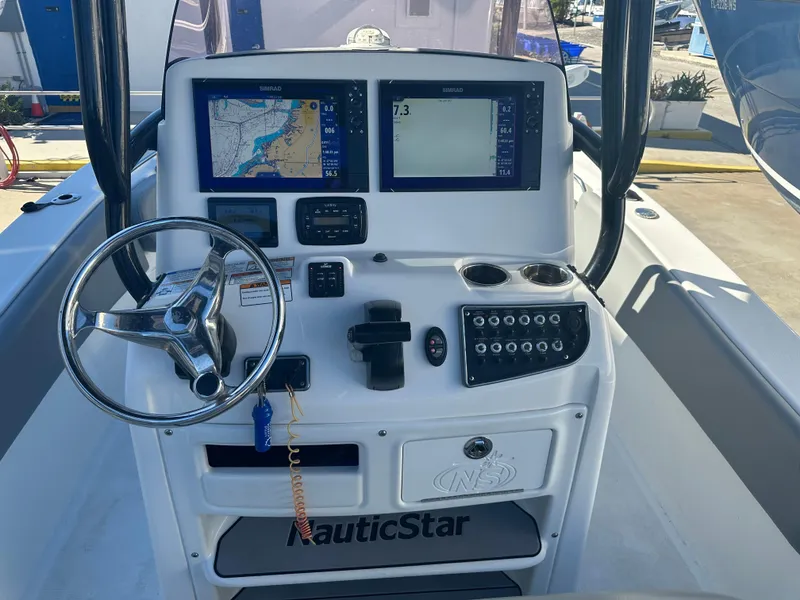 Slide: The Image of NauticStar Legacy 2302 boat console with navigation screens and controls, 2022 model. - 31