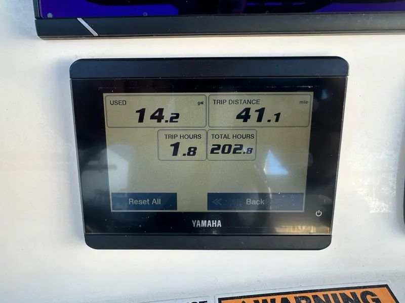 Slide: The Image of Yamaha display showing fuel usage and trip data on NauticStar Legacy 2302, 2022 model. - 32