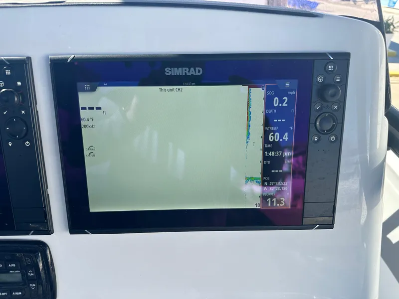 Slide: The Image of Simrad display on 2022 NauticStar Legacy 2302 boat dashboard. - 34