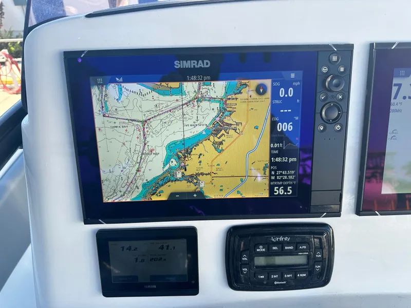 Slide: The Image of Simrad navigation display on 2022 NauticStar Legacy 2302 boat dashboard. - 35