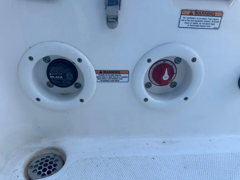 Slide: The Image of NauticStar Legacy 2302 boat controls and warning labels, 2022 model. - 36