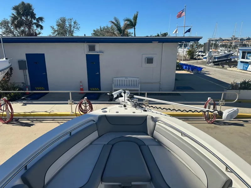 Slide: The Image of 2022 NauticStar Legacy 2302 boat docked at marina with clear blue sky. - 37