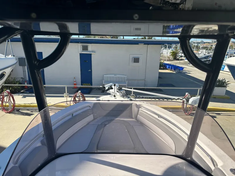Slide: The Image of 2022 NauticStar Legacy 2302 boat interior at a marina. - 38