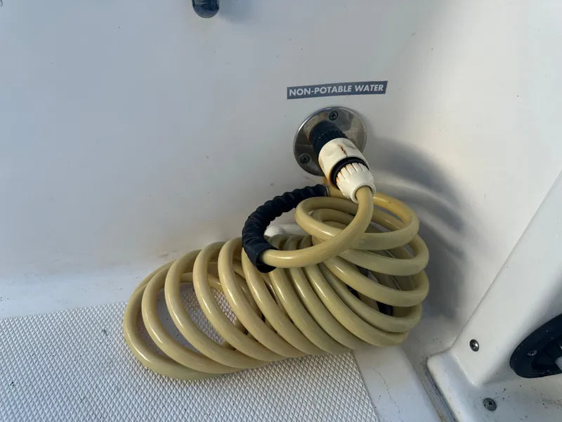 Slide: The Image of Coiled hose labeled "Non-Potable Water" on 2022 NauticStar Legacy 2302 boat. - 41
