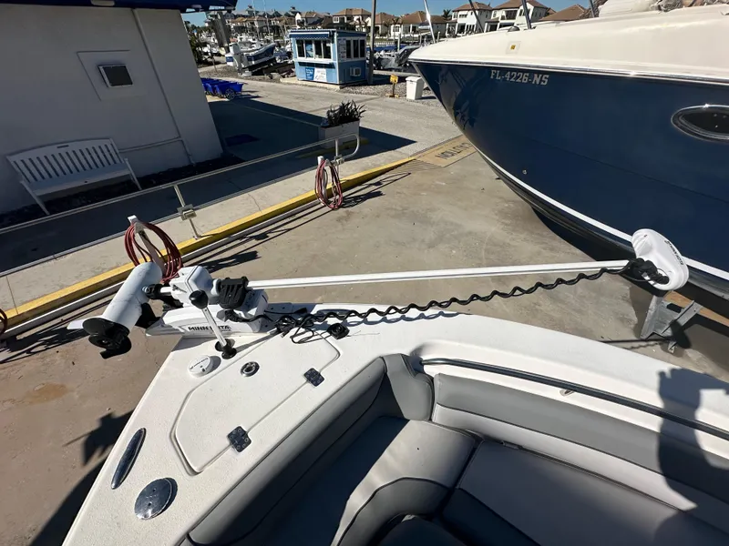 Slide: The Image of 2022 NauticStar Legacy 2302 boat with trolling motor at marina. - 42