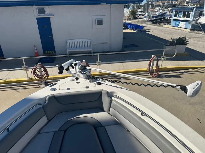 Slide: The Image of 2022 NauticStar Legacy 2302 boat docked at marina with trolling motor. - 44