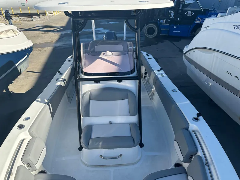 Slide: The Image of 2022 NauticStar Legacy 2302 boat interior with seating and console. - 45