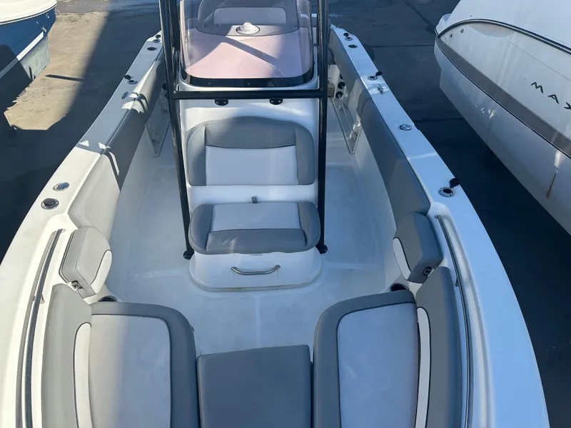 Slide: The Image of 2022 NauticStar Legacy 2302 boat interior with cushioned seating and console. - 46