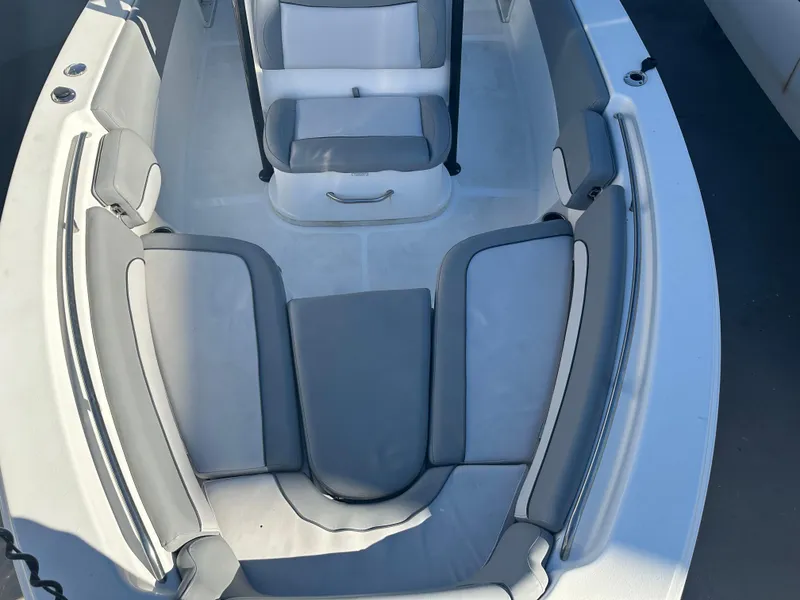 Slide: The Image of 2022 NauticStar Legacy 2302 boat interior with gray seating and white deck. - 47