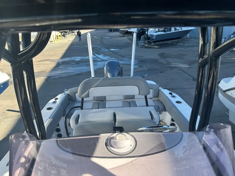 Slide: The Image of 2022 NauticStar Legacy 2302 boat interior view at a marina. - 48