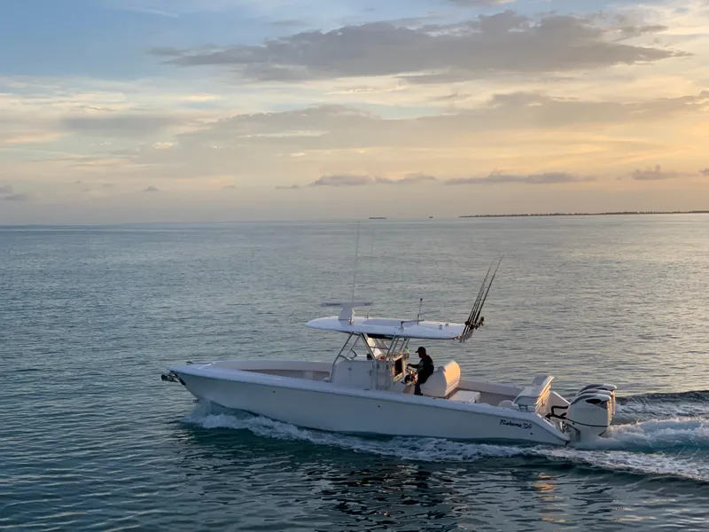 Slide: The Image of 2015 Bahama 34 boat cruising on calm ocean at sunset. - 1