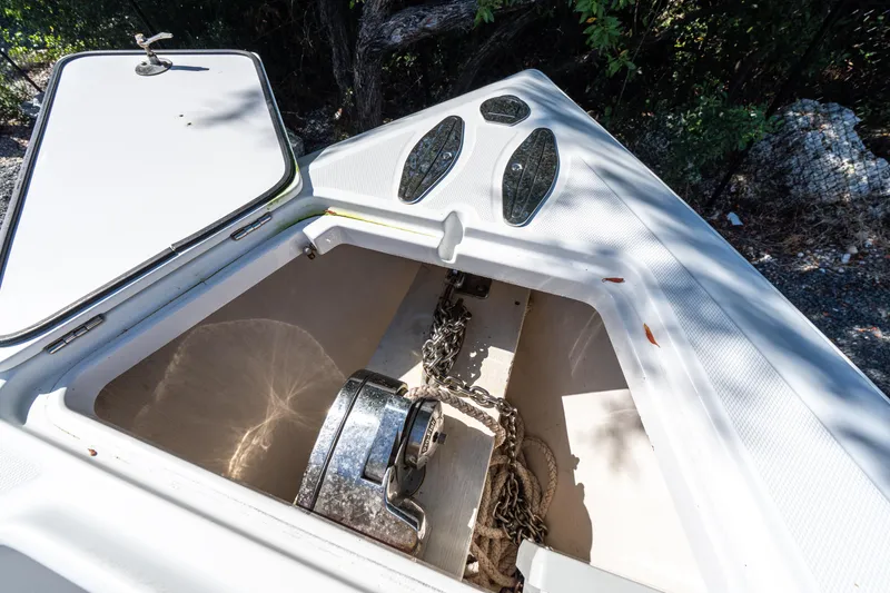 Slide: The Image of Anchor compartment of 2015 Bahama 34 boat with chains and winch. - 11