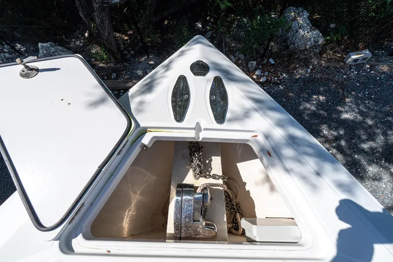 Slide: The Image of Open anchor compartment on 2015 Bahama 34 boat, showing chain and winch. - 12