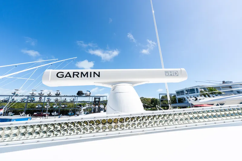 Slide: The Image of 2015 Bahama 34 boat with Garmin xHD radar under clear blue sky. - 14