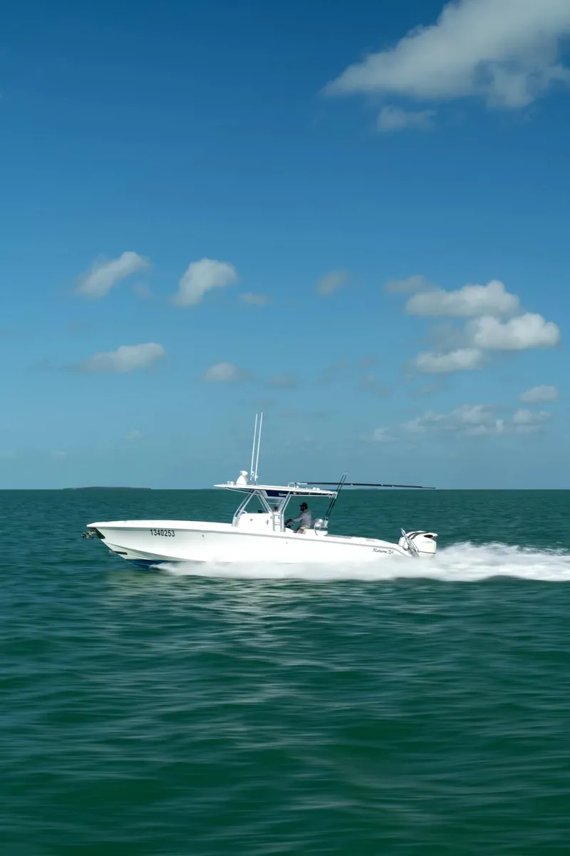 Slide: The Image of 2015 Bahama 34 boat cruising on open sea under clear blue sky. - 2