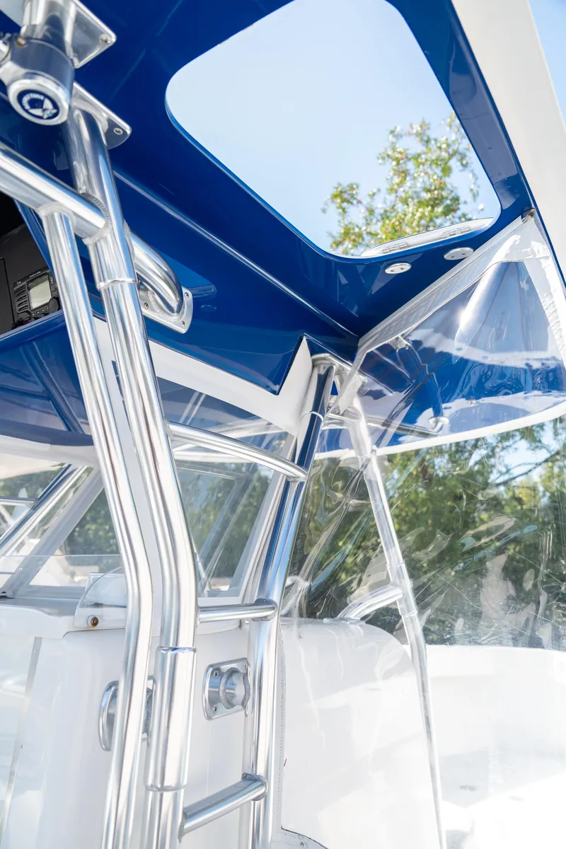 Slide: The Image of 2015 Bahama 34 boat interior with blue canopy and chrome details. - 20