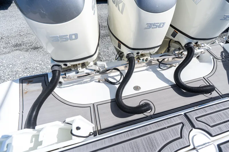 Slide: The Image of Triple Suzuki 350 engines on a 2015 Bahama 34 boat, featuring sleek deck design. - 25