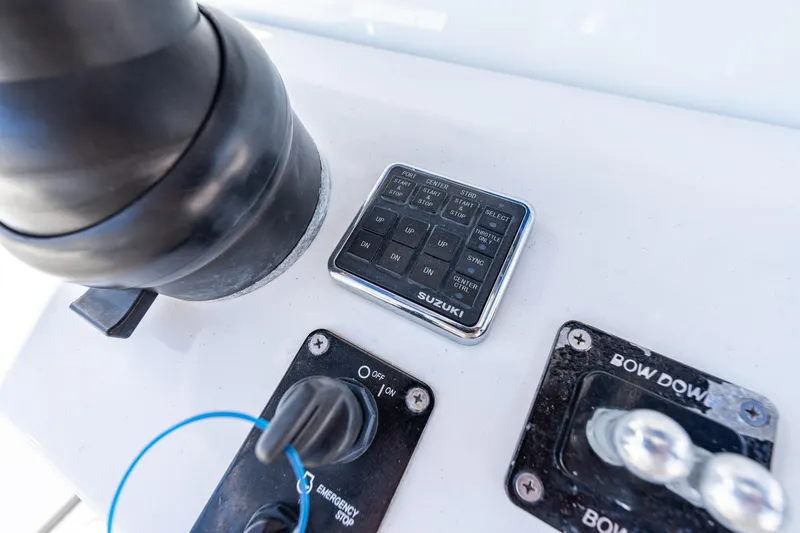Slide: The Image of Control panel of a 2015 Bahama 34 boat featuring Suzuki components. - 26