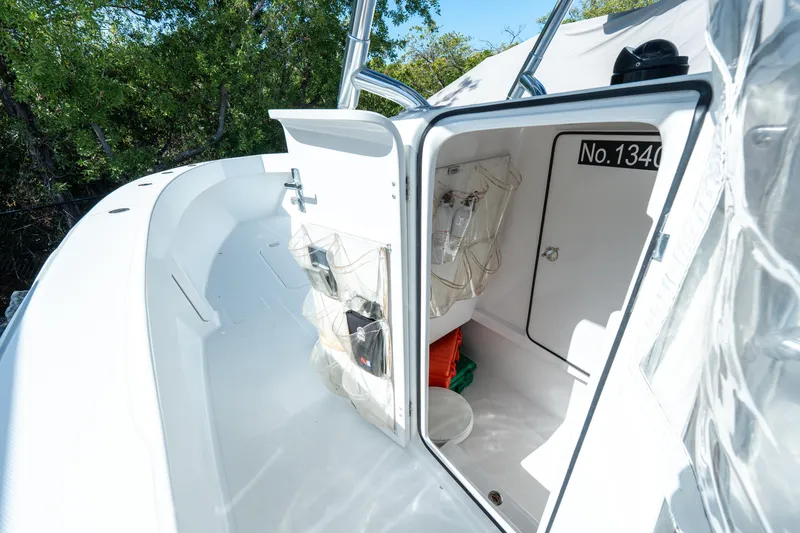 Slide: The Image of 2015 Bahama 34 boat storage compartment with organized gear and equipment. - 27