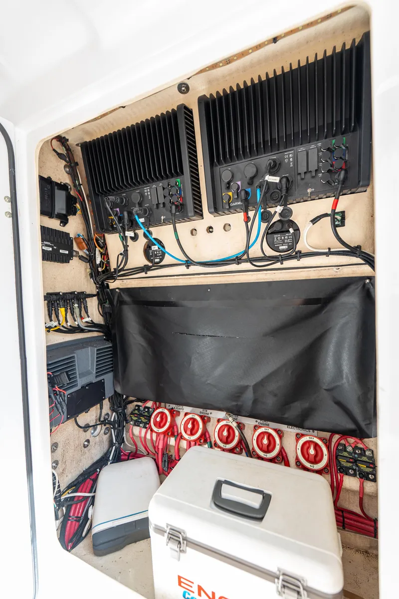 Slide: The Image of Electrical system inside a 2015 Bahama 34 boat, featuring wiring and equipment. - 29