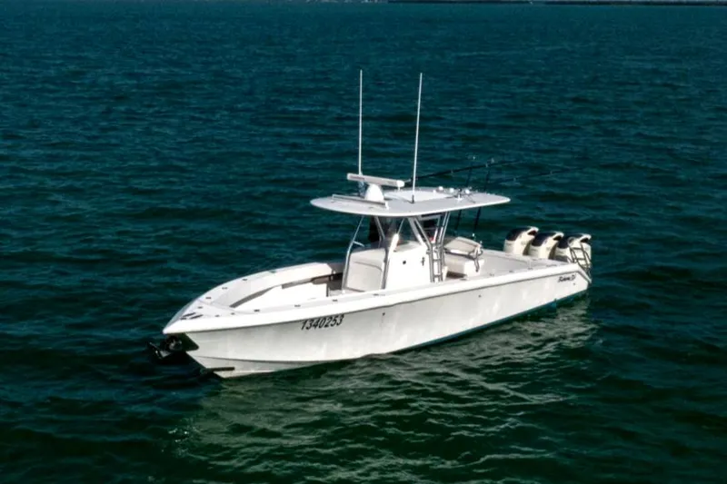 Slide: The Image of 2015 Bahama 34 boat on open water with triple outboard engines. - 3