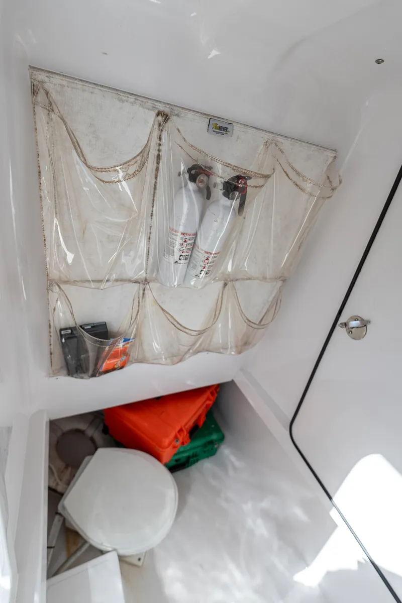 Slide: The Image of Interior storage area of a 2015 Bahama 34 boat with safety equipment. - 30