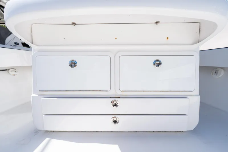 Slide: The Image of Storage compartments on a 2015 Bahama 34 boat, featuring sleek white design. - 32