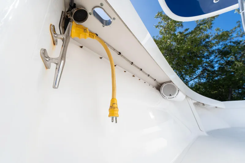 Slide: The Image of Yellow power cable on 2015 Bahama 34 boat, with cleat and speaker visible. - 34