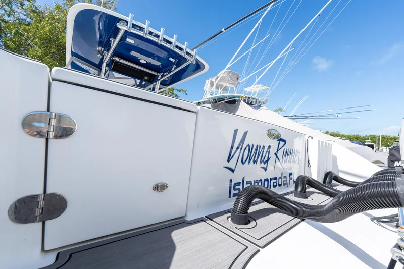 Slide: The Image of 2015 Bahama 34 boat with "Young Runner" text, docked under clear blue sky. - 37