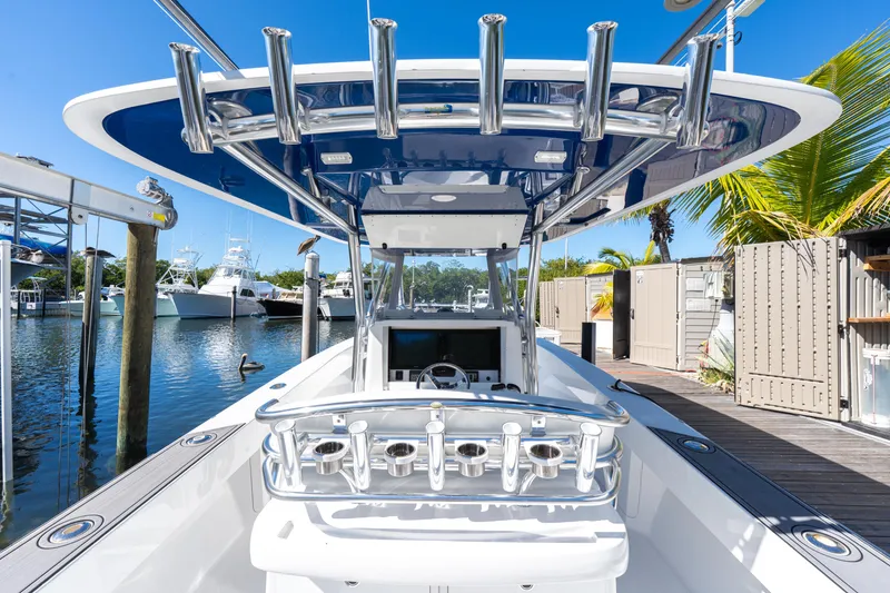 Slide: The Image of 2015 Bahama 34 boat docked, featuring sleek design and modern amenities. - 46