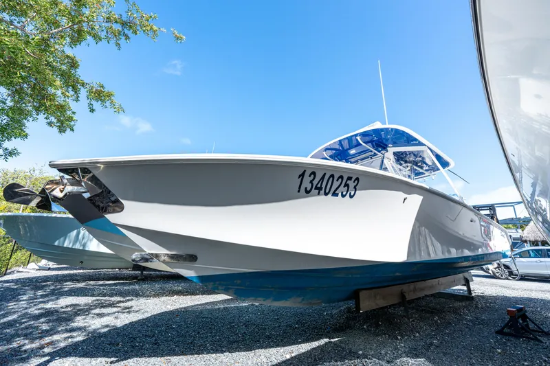 Slide: The Image of 2015 Bahama 34 boat on display, hull number 1340253, under clear blue sky. - 5