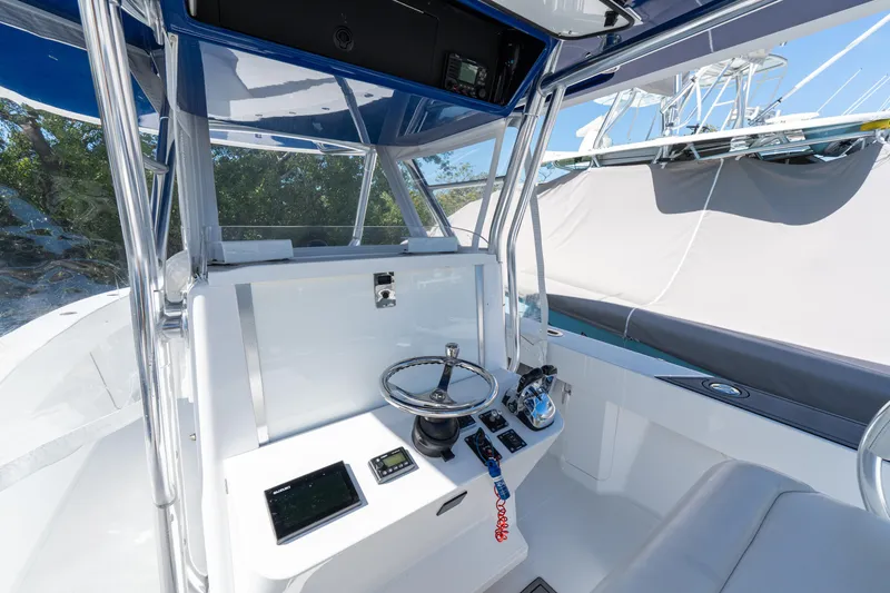 Slide: The Image of 2015 Bahama 34 boat cockpit with steering wheel and navigation controls. - 7