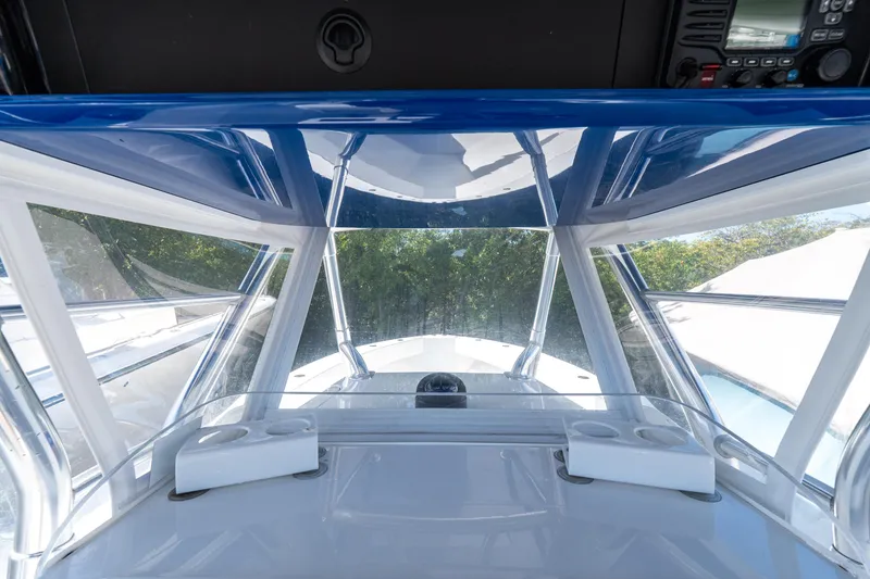 Slide: The Image of Interior view of 2015 Bahama 34 boat cockpit with clear windshield and control panel. - 8
