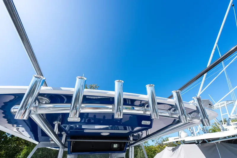Slide: The Image of 2015 Bahama 34 boat with rod holders against a clear blue sky. - 9