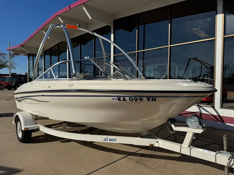 Slide: The Image of 2002 Bayliner 185 BR boat on trailer outside a showroom. - 10