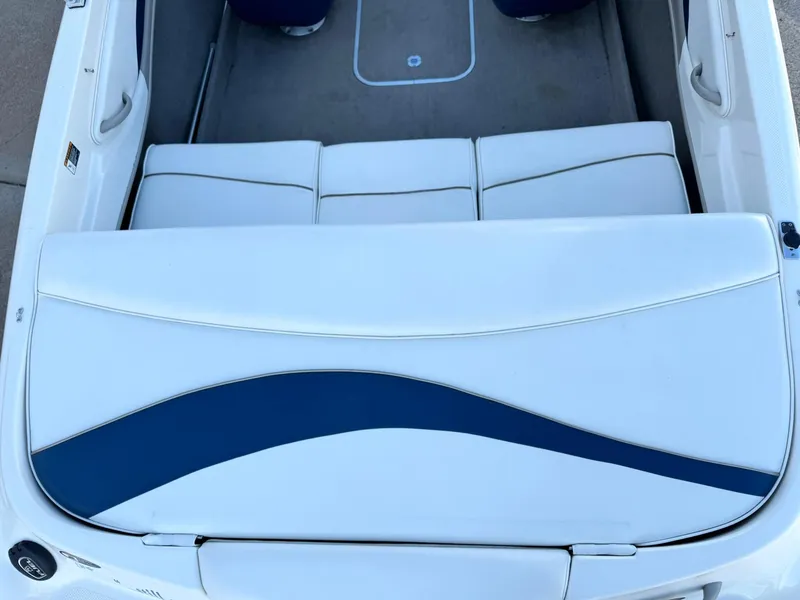 Slide: The Image of 2002 Bayliner 185 BR boat interior with white and blue seating. - 13