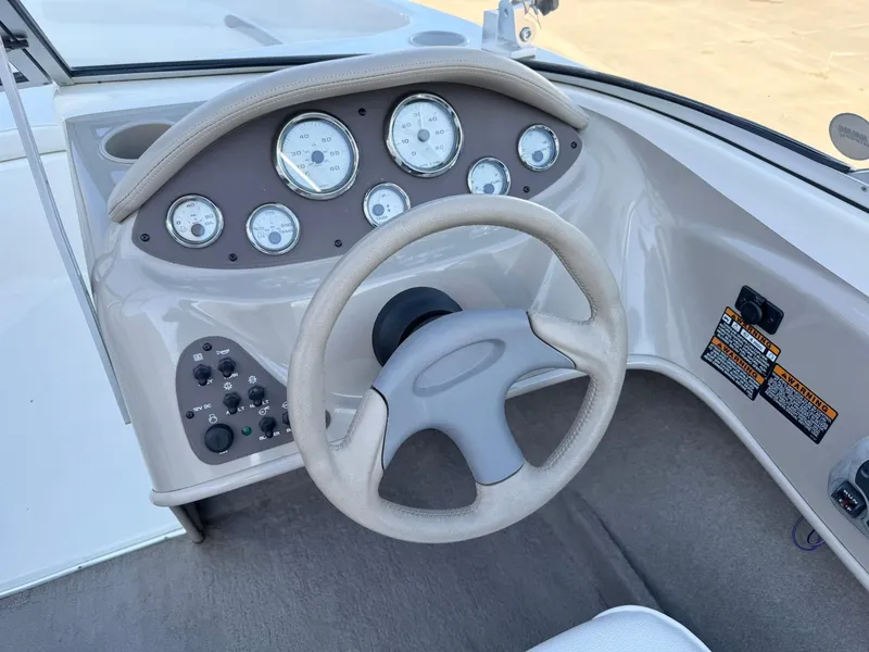 Slide: The Image of Dashboard of a 2002 Bayliner 185 BR boat with steering wheel and gauges. - 16