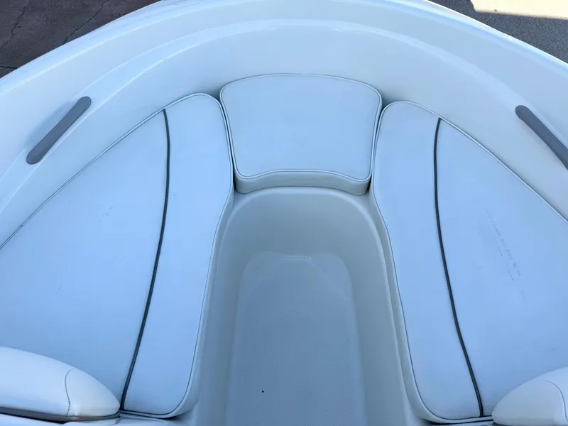 Slide: The Image of 2002 Bayliner 185 BR boat interior with white cushioned seating. - 18