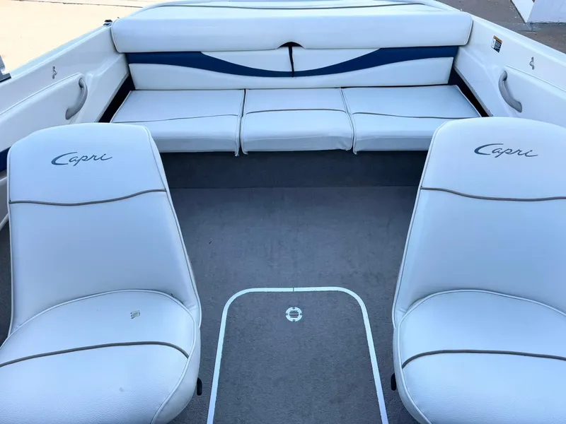 Slide: The Image of 2002 Bayliner 185 BR boat interior with white Capri seats and rear bench. - 19